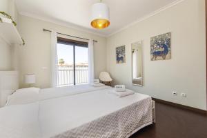 a white bedroom with a large bed and a window at B03 - Luxury 2 Bed near Lagos Marina in Lagos +39 photos