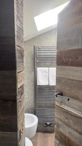 a bathroom with a toilet and a sink and a window at TERRY LODGE-Luxury Apartment-central ski area in Aprica +62 photos