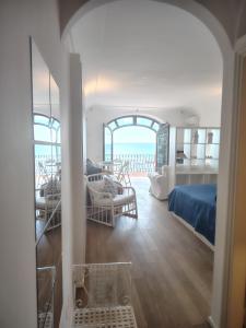 a living room with a bed and a room with a view at Casa vista Faraglioni Capri 2 in Capri