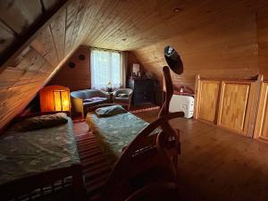 a attic room with a bed and a couch at Pirts Baudas in Sīveci