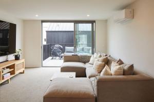 un salon avec un canapé et une table dans l'établissement Spacious 3 Bedroom Townhouse Steps from the CBD, à Linwood