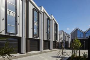 une rangée de maisons avec des portes et des fenêtres noires dans l'établissement Spacious 3 Bedroom Townhouse Steps from the CBD, à Linwood