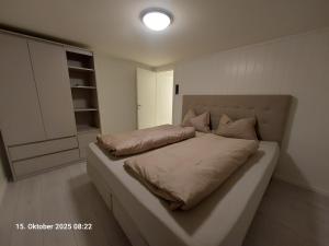 a bedroom with a large bed with pillows on it at Nordlys Apartment in Hamnvik