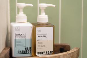 two bottles of soap sitting next to each other at The Yard Hostel Chiang Mai in Chiang Mai