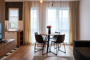 a living room with a table and chairs at BCB Aparts Wood Nest in Floreşti