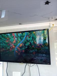 a flat screen tv sitting on top of a wall at Gyps Vikendica with Swimming Pool and Sauna in Tuzla +12 photos