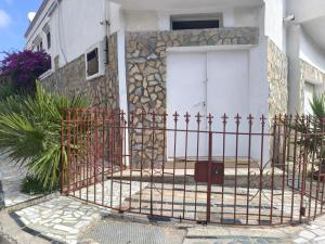 a gate in front of a house with a white door at Bizerte Tunisia cozy studio in Bizerte