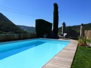 a blue swimming pool with a chair in a yard at Bed and Breakfast Casa del Nonno in Adrara San Martino