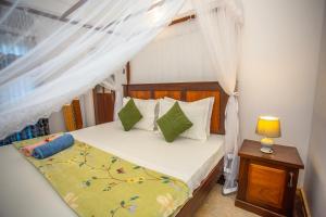 a bedroom with a bed with a canopy at Saku Residence in Unawatuna +85 photos