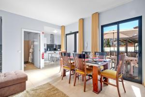 a dining room and living room with a table and chairs at Mimi Holiday House - Free Parking in Funchal