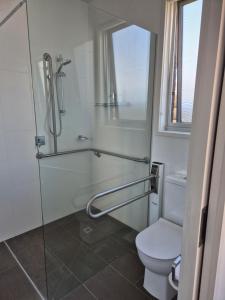a bathroom with a glass shower and a toilet at Whaler's Cove in Portland