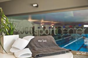 a towel sitting on a table next to a pool at Mio Sud in Cosenza