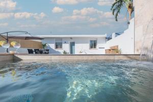a swimming pool in the backyard of a house at Mirador de la Peña in Arcos de la Frontera