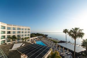 an aerial view of a hotel with a swimming pool and the ocean at Evalena Beach Hotel in Protaras