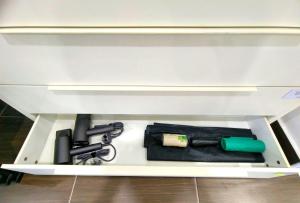 a white drawer with a gun and a lighter at GD Corner Lot 10pax Water Dispenser BBQ Neflix Games in Masai