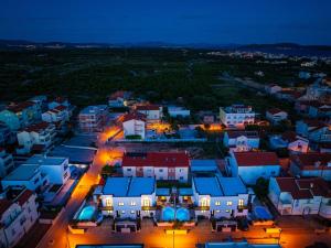 an aerial view of a town at night at Villa Essenza Mare in Vodice with private pool & pet friendly - only 650 meters from the beach in Vodice