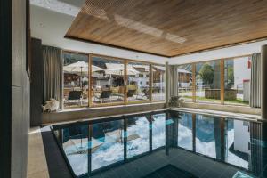 an indoor pool with a view of a building at Apart-Hotel Laurus Lech in Lech am Arlberg