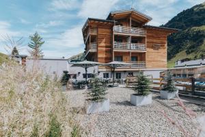 a large building with trees in front of it at Apart-Hotel Laurus Lech in Lech am Arlberg