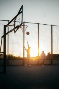 a woman is playing basketball on a court at fabrik studio apartments in Chemnitz