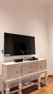 a white dresser with a television on top of it at The Classic Crown- Near Lake Pichola in Jāmb +32 photos