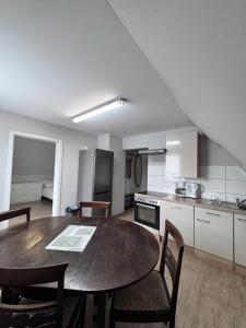 a kitchen with a table and chairs in a room at Asiatisches Landhaus Pension in Braunsbedra