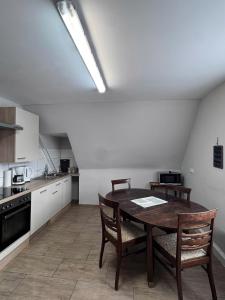 a kitchen with a table and chairs in a room at Asiatisches Landhaus Pension in Braunsbedra +54 photos