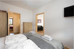a bedroom with a large bed with towels on it at Am Wiesengrund in Lebus