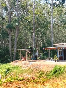 a playground in front of a house with trees at Abu Sea Man House in Ko Lanta Yai +73 photos