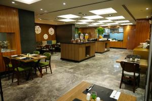 a restaurant with tables and chairs and a bar at The Grand Lux Hotel in Doha
