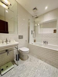ein Badezimmer mit Toilette, Waschbecken und Badewanne in der Unterkunft Charming 1BR City Retreat soho&covent garden in London