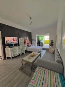 a living room with a couch and a tv at Studio in downtown Rabat in Rabat