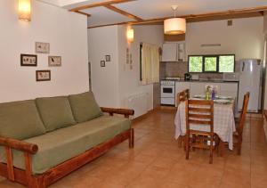 a living room with a couch and a kitchen at Aparts La Balconada by DOT Suites in Villa Pehuenia