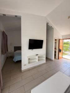 a living room with a flat screen tv on a wall at Secret Bungalow, Los Arcos in San Bartolomé