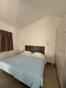 a bedroom with a large white bed with two pillows at Secret Bungalow, Los Arcos in San Bartolomé +13 photos