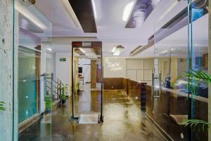 an empty hallway of an office with a glass door at Hotel O" Delhi-Near Karol Bagh Metro Station in New Delhi