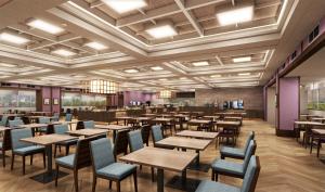 a restaurant with tables and chairs in a room at KAMENOI HOTEL Kusatsu Resort in Kusatsu