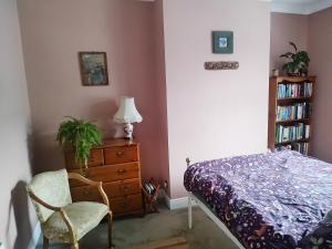 a bedroom with a bed and a dresser and a chair at Bishop bed and breakfast in Bishop Auckland
