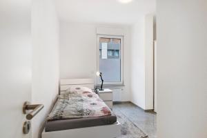 a small room with a bed and a window at Haus Rosa in Albstadt