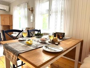 a wooden table with wine glasses on top of it at Cabin in Lofoten - Northern Lights view  +24 photos