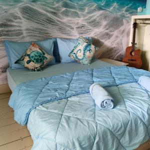 a bed with pillows on it in a bedroom at Turtle Garden Lodge in Semporna