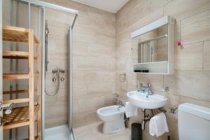 a bathroom with a sink and a toilet and a shower at Terrazza Paradiso by Quokka 360 - Spacious Design Flat with Terrace in Paradiso +49 photos