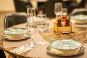 a table with plates and wine glasses on it at Hotel Terme 36.6 in Priboj