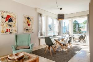 a living room with a table and chairs at Terrazza Paradiso by Quokka 360 - Spacious Design Flat with Terrace in Paradiso