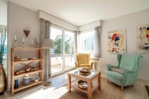 a living room with two chairs and a table at Terrazza Paradiso by Quokka 360 - Spacious Design Flat with Terrace in Paradiso