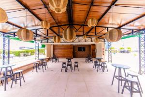 a large room with tables and chairs and a stage at Quality Hotel Aracaju in Aracaju
