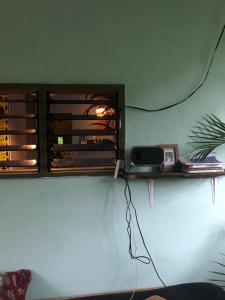 a shelf on a wall with a phone on it at The Art House in Villasis