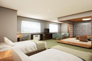a hotel room with two beds and a living room at KAMENOI HOTEL Kusatsu Resort in Kusatsu