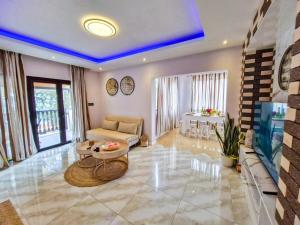 a living room with a couch and a table at Blue vibes in Flic-en-Flac