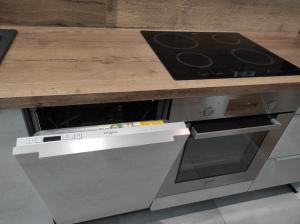 a wooden counter top over a stove top oven at Moderný apartmán pri lesoparku in Košice