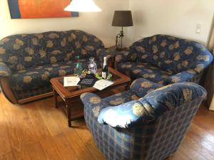 a living room with two couches and a table at Ferienhaus Berta in Süderende